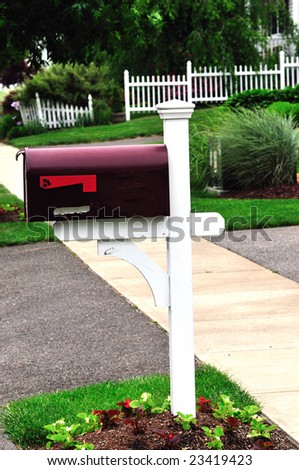 a beautiful red metal mail box at an american home