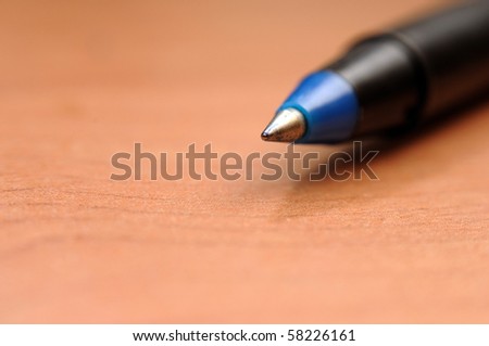 Writing pen isolated on the brown background