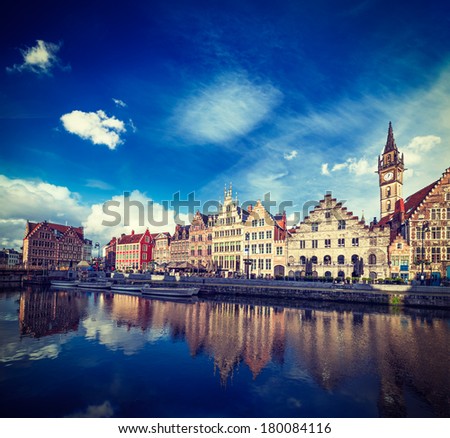 Vintage retro hipster style travel image of Europe Belgium medieval town travel background - Ghent canal and Graslei street on sunset. Ghent, Belgium