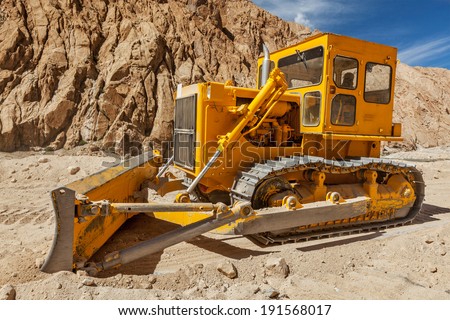 LADAKH, INDIA - SEPTEMBER 8, 2011: Bulldozer doing road construction in Himalayas. Ladakh, Jammu and Kashmir, India