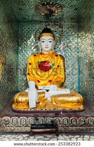 Buddha statue in Burma famous sacred place and tourist attraction landmark - Shwedagon Paya pagoda. Yangon, Myanmar