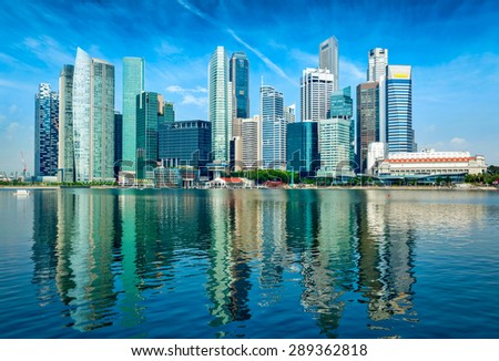 Modern Singapore city skyline of business district downtown in day with reflection in water