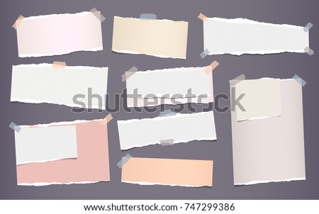 White and colorful ripped strips, notebook, note paper for text or message stuck with sticky tape on gray background.