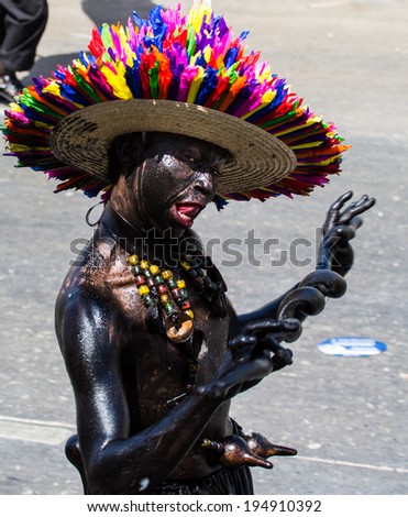 Barranquilla, Colombia - March 1, 2014 - Performers in elaborate costume sing, dance, and stroll their way down the streets of Barranquilla during the Battalla de Flores during Carnival