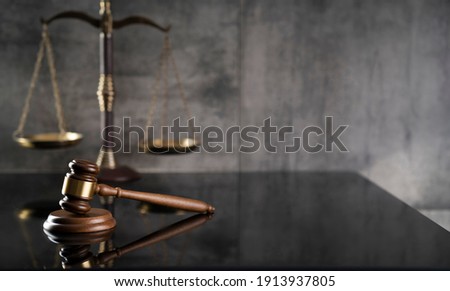 Law and Justice concept. Mallet of the judge. Gray background, place for typography. Courtroom theme.