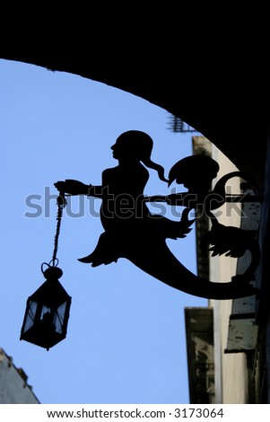 The silhouette of street lamp in form of mermaid