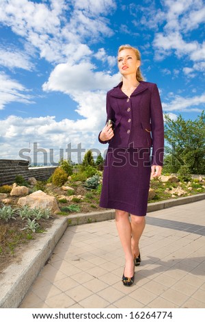 Beautiful Young Woman in suit on the street. In all growth.