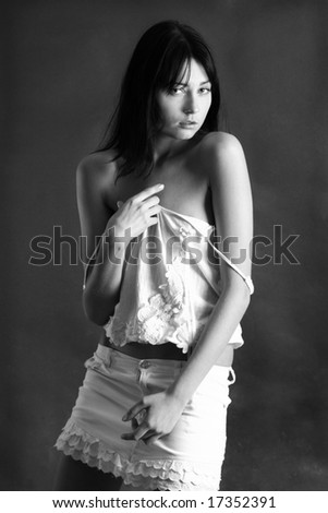 Black & White portrait beautiful, sexy, sad expression young brunette woman. In the studio.