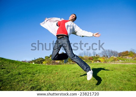 Happy young man - jumping  end flies in blue sky