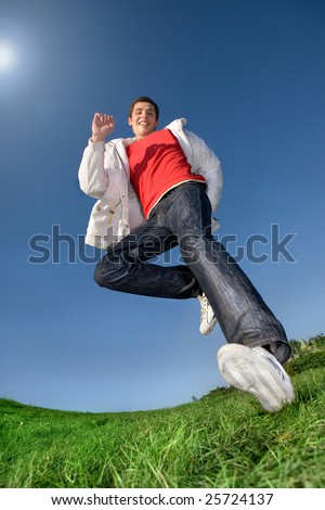 Happy young man - jumping  end flies in blue sky