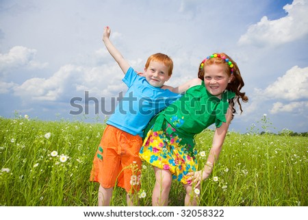 Two golden-haired children playing the field