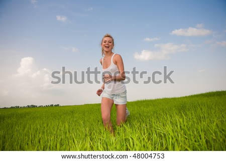 Happy young women running in field