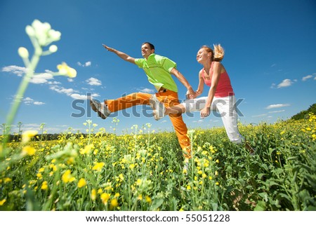 Happy people is jumping in field