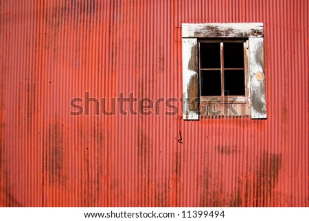the side of a red bard and its window