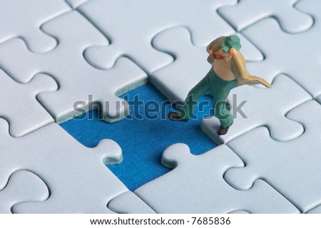 plastic figure falls into a puzzle hole