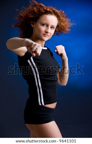 young sporty woman is practicing martial arts