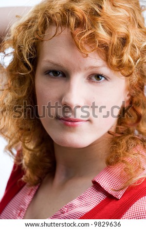 Portrait of a young red-haired woman looking into the camera