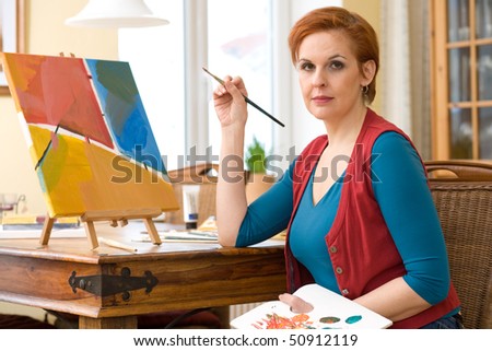 female artist painting in her living room