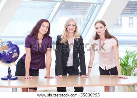 three girls in business outfit looking serious