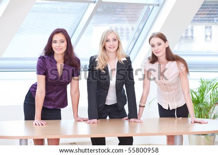 three girls in business outfit looking concentrated