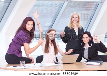 smart women in business outfit jubilating in front of the window