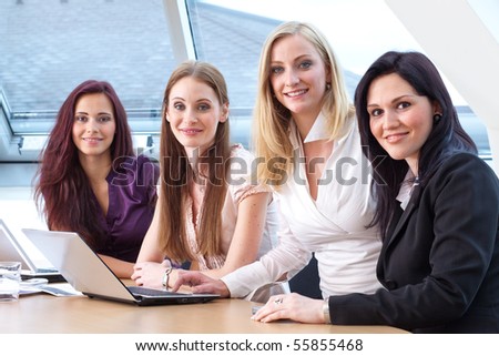 young female boss and employees smile during work