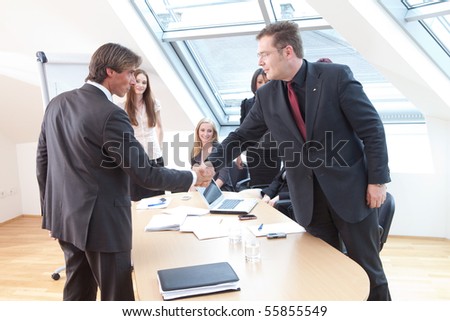 shake hands between boss and a new client