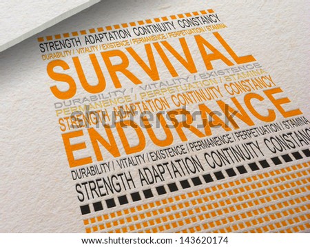 The word Survival letter pressed into paper with associated words around it.