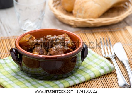 stew with mushrooms in a terracotta bowl