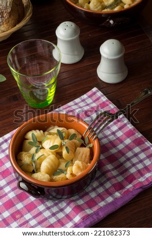Gnocchi with butter and sage in a terracotta bowl