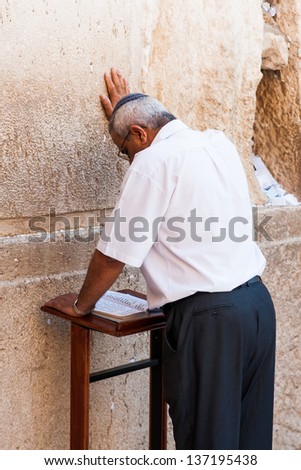 JERUSALEM, ISRAEL - CIRCA JULY 2009: Unidentified Jew prays at the Western Wall called also Wailing Wall circa July 2009. Wailing Wall is the most sacred place for Jews from all over the world.