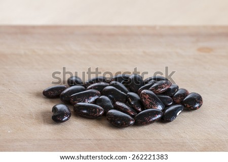 Celebration runner beans dried ready for sowing, on wooden board