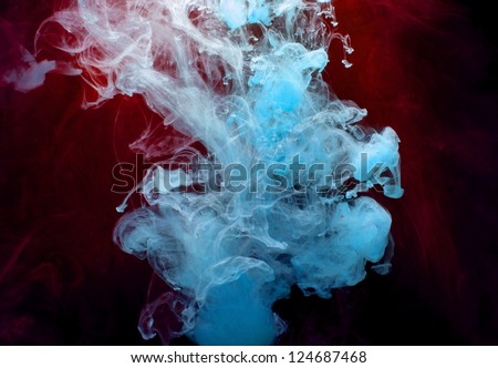 Blue and red Ink in water on a black background.
