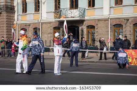VLADIVOSTOK, RUSSIA - NOVEMBER 16: torchbearer carries the Olympic flame in relay of Olympic Flame on November 16, 2013 in Vladivostok, Russia.