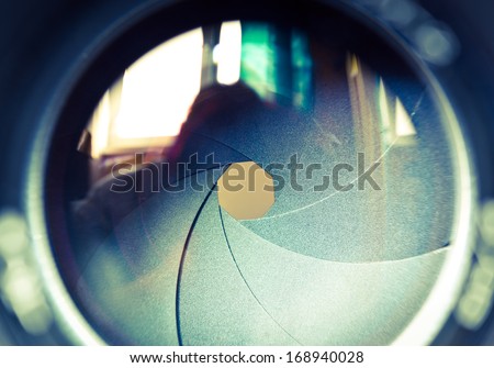 The diaphragm of a camera lens aperture. Selective focus with shallow depth of field. Color toned image.