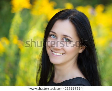 Woman smiling happy on sunny summer or spring day. Summer girl portrait. Selective focus on eyes.