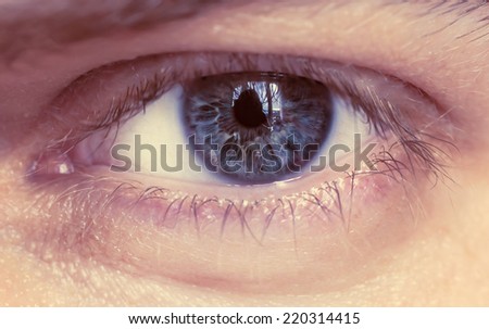 Blue man eye, macro shot. Shallow depth of field. Color toned image.