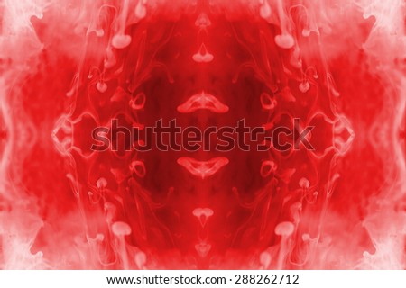 Red ink forming patterns resembling Rorschach Test ink blots.