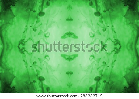 Green ink forming patterns resembling Rorschach Test ink blots.