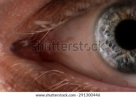 Blue man eye with contact lens, macro shot. Shallow depth of field.