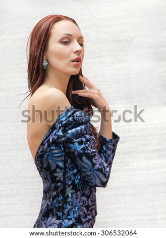 Beautiful woman in blue shiny dress.