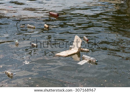 Oil and garbage pollution in the water. Selective focus with shallow depth of field.
