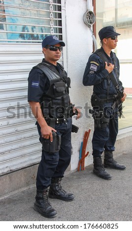PUERTO VALLARTA, MEXICO - FEBRUARY 8:   Two policemen watch the activities on February 8, 2014 at  Constitucion Avenue in Puerto Vallarta, Mexico
