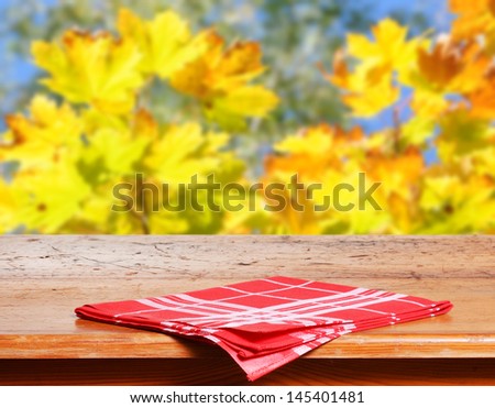 Empty wooden table for product display montages - autumn theme