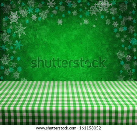 Empty gingham table with green christmas background