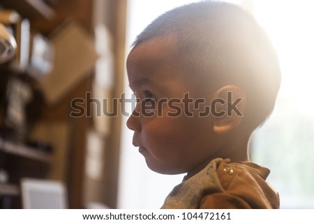 Two years old Bolivian child, closeup profile against white natural background