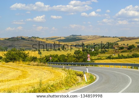 Crete senesi, characteristic landscape in Val d\'Orcia (Siena, Tuscany, Italy). The road to Asciano