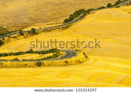 Crete senesi, characteristic landscape in Val d\'Orcia (Siena, Tuscany, Italy). Winding road