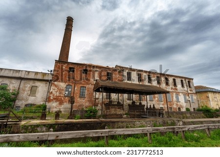 Similar – Image, Stock Photo Old industrial building with street and cheerful pennant shadow