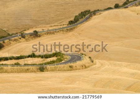 Crete senesi, characteristic landscape in Val d\'Orcia (Tuscany, Italy). The winding road from Siena to Asciano